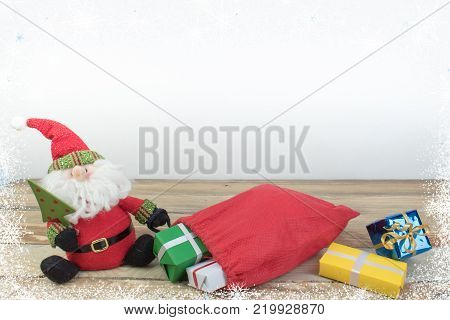 Christmas holidays composition on wooden background.. Santa claus carries gifts in a bag
