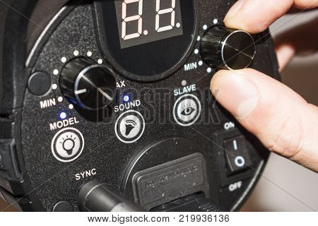 hand adjusts the flash light candlestick behind