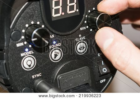 hand adjusts the flash light candlestick behind