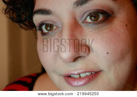 Close up view of ethnic woman with short hair showing curious expression