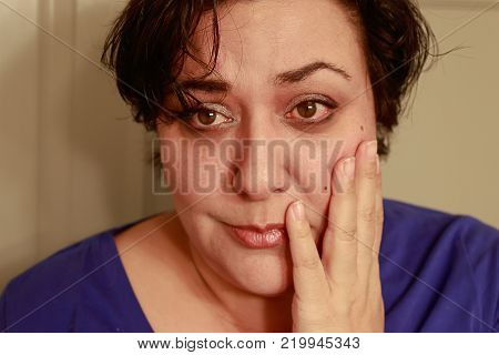 Close up view of ethnic woman with short hair showing sad expression