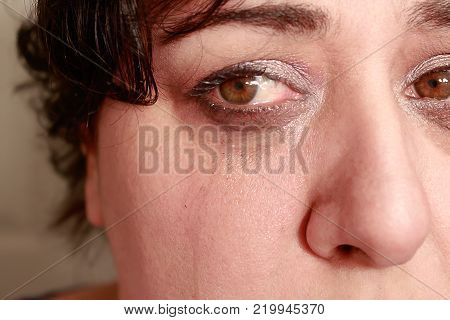 Close up view of ethnic woman with short hair showing crying expression