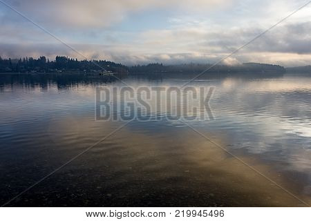 blue and gold clouds reflecting on foggy puget sound