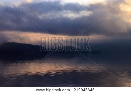 purple and gold clouds reflecting on foggy puget sound