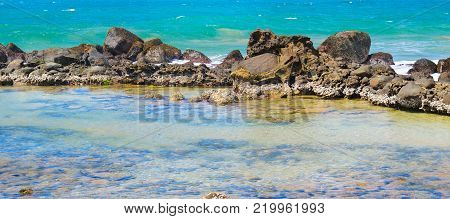 The lagoon is separated from the ocean by a coral reef.Tropical seascape. A bright sunny day. Wide photo.