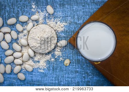 Close Up Of Ayurvedic Herb Kuanch,cowhage,mucuna Pruriens With Powder And Milk Glass.;