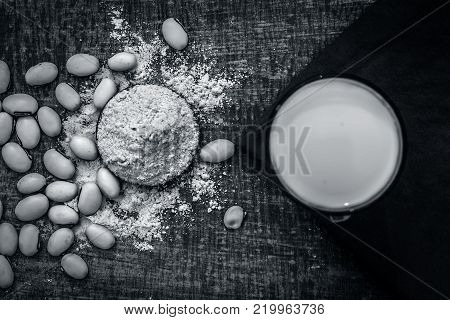 Close Up Of Ayurvedic Herb Kuanch,cowhage,mucuna Pruriens With Powder And Milk Glass.;