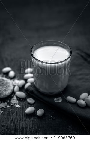 Close Up Of Ayurvedic Herb Kuanch,cowhage,mucuna Pruriens With Powder And Milk Glass.;