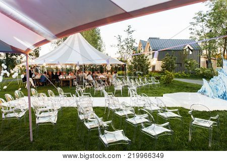Outdoor wedding ceremony in the forest and wedding tents.