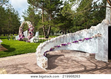 Outdoor wedding ceremony with umbrellas in the forest.
