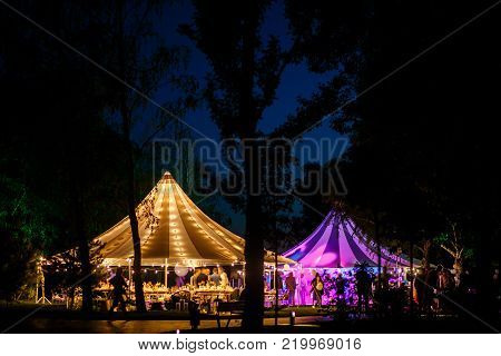 Colorful wedding tents at night. Wedding day.