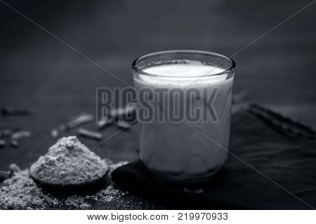 Close Up Of Ayurvedic Herb   Satavari,asparagus Racemosus With Its Powder And Root With Milk Glass.