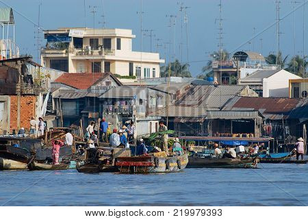 CAI BE, VIETNAM - FEBRUARY 16, 2007: Unidentified people visit famous floating market in Cai Be, Vietnam. Cai Be is often called Venice of Indochina.