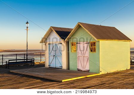 2 beach huts painted in pastel colours on Southend Pier