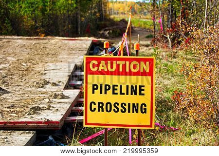 Closeup of a caution pipeline crossing sign.
