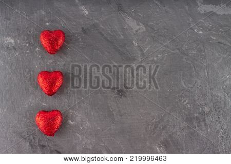 Red hearts on a gray background. The symbol of the day of lovers. Valentine's Day. Concept February 14
