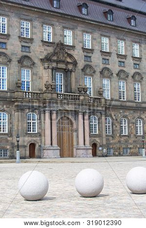 Copenhagen, Denmark - June 22, 2019: Facade Of Christiansborg Palace With Decorative Great Stone Sph