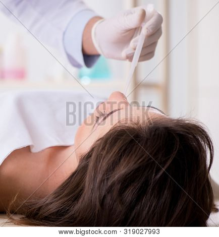Police coroner examining dead body corpse in morgue