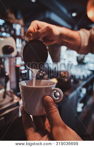 Diligent Barista Is Prepairing Fresh Latte For Customers For Coffee Break At Caffeteria.