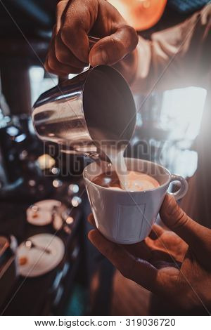 Diligent Barista Is Prepairing Fresh Latte For Customers For Coffee Break At Caffeteria.