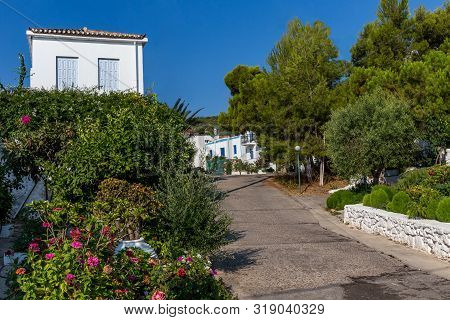 Walking On Traditioanal Greek Streets With White House, Spetses Saronic Gulf, Greece