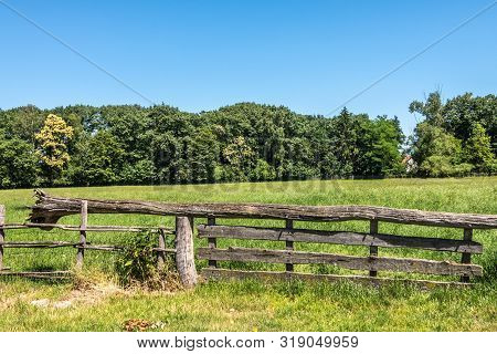 Bokrijk, Belgium - June 27, 2019: Closeup Of Old Gray Wooden Gate Closure With Tree Balance Beam To 