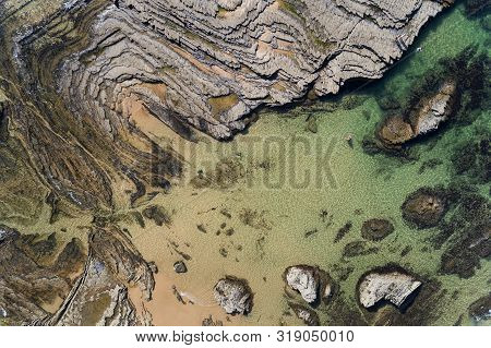 Aerial View Of The Rock Formations At The Carreagem Beach In Aljezur, Algarve;