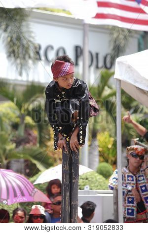 Davao City, Philippines-august 2014: A Boy Balances Himself On Bamboos Pole At The Streetdancing Com