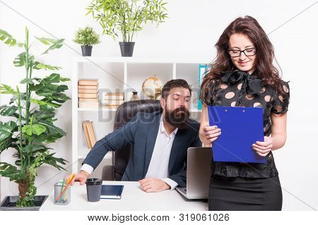 Charming Nerd. Sexy Female Employee With Nerd Look Standing In Front Of Employer. Adorable Nerd Girl