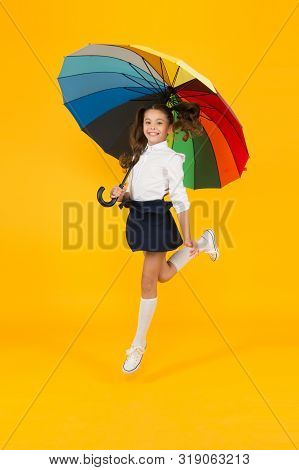 Back To School On September 1. Adorable Schoolgirl With Rainbow Umbrella On September 1 On Yellow Ba