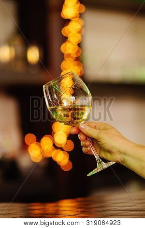 Hand Sommelier Holding Glass Of White Wine. Wine-tasting. White Wine Concept. Wine Tour. Vertical, W