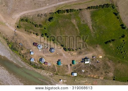 Aerial Top View Of A Settlement In The Altai Mountains With Small Houses For Indigenous People And T