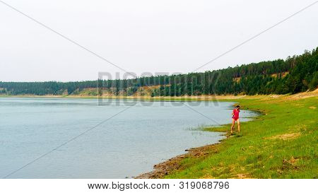 Yakut Asian Girl The Lady Angler Goes Fishing Spinning Reel In A Bathing Suit Along The Wild North O