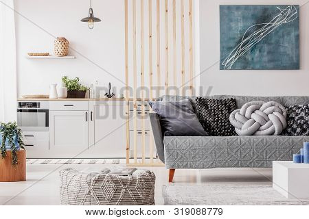 Abstract Blue Painting On Empty White Wall Of Open Plan Apartment