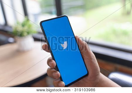 Chiang Mai, Thailand - Aug.24,2019: Man Using Twitter App On Xiaomi Mi Mix 3. 
Twitter Is An Online 