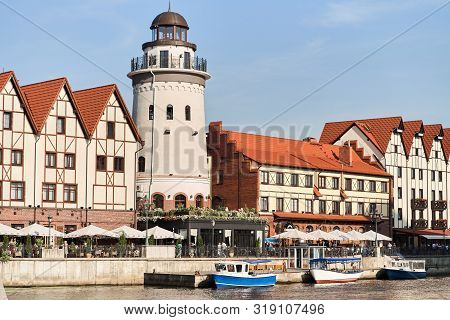 Kaliningrad, Russia - August 24, 2019: View Of The Fish Village And Lighthouse On The Embankment Of 
