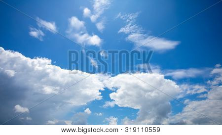 Deep Blue Sunny Sky With White Clouds. Blue Sky With Cloud Closeup. White Fluffy Clouds In The Blue 
