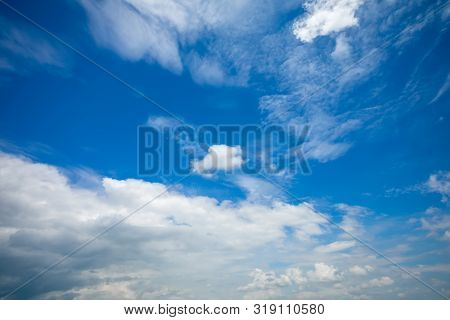 Deep Blue Sunny Sky With White Clouds. Blue Sky With Cloud Closeup. White Fluffy Clouds In The Blue 