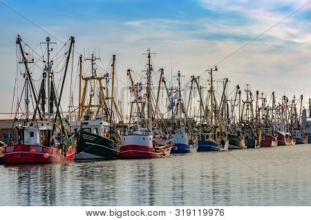 Fishing Boats In The Harbor Of Buesum On The North Sea In Germany Against The Blue Sky, Copy Space