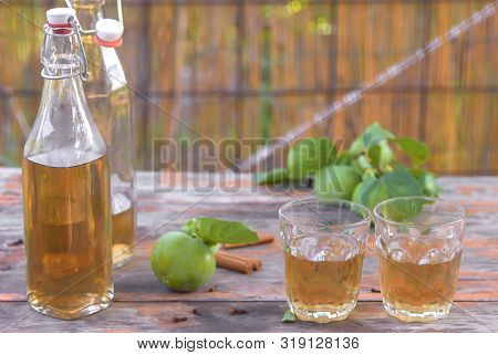 Apple Cider Poured Into Bottles. Glasses Filled With Apple Cider Vinegar Stand On An Old Vintage Tab