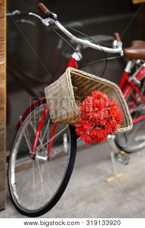 Romantic View Of Bike With Bouquet Of Red Flowers On Street Of Town. A Pleasant Surprise.
