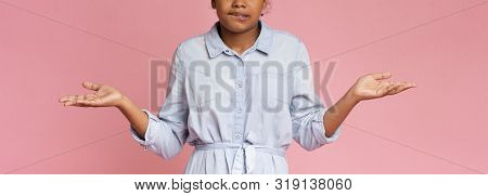 I Didnt Do It. Confused Black Teen Girl Biting Lip And Shrugging Shoulders