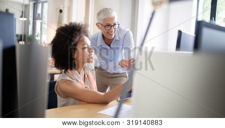 Successful Group Of Business People At Work In Office