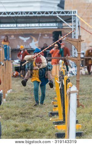Bulgar, Russia 11-08-2019: Two Buffoons Having Fun On The Battlefield On Medieval Festival - Holding
