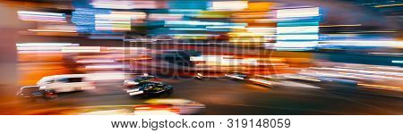 Abstract Blurred View Of People And Traffic Crossing A Busy Intersection In Shibuya, Tokyo, Japan