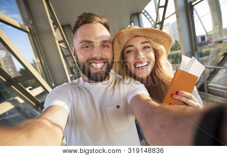 Excited Couple Making Selfie At Airport Terminal, Waiting For Departure