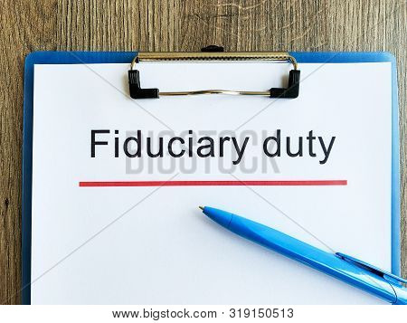 Paper With Text Fiduciary Duty On Wood Table.