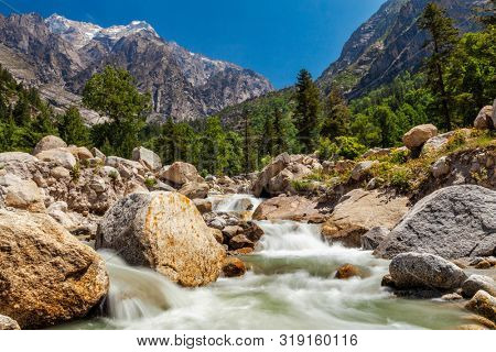 Mountain stream with waterfall cascades in Himalayas. Sangla valley, Himachal Pradesh, India