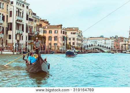Venice, Italy - May 25, 2019: View Of Grand Canal Full Of Boats And Gandolas Rialto Bridge On Backgr