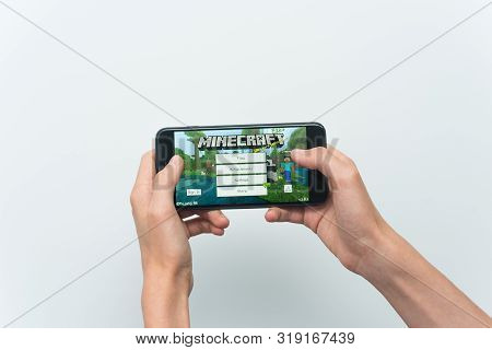 Samara, Russia -07, 29, 2019: A Young Guy Playing Minecraft Game On Iphone 8 Plus. Teenage Boy Holdi